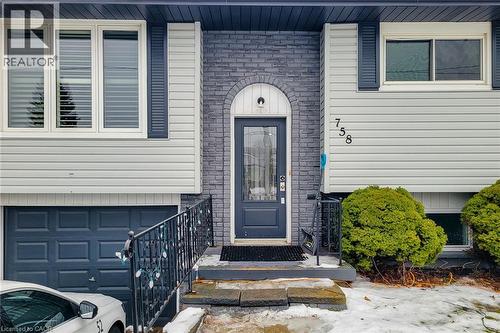 Property entrance with a garage and brick siding - 758 Stone Church Road E, Hamilton, ON - Outdoor