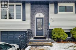 Property entrance with a garage and brick siding - 