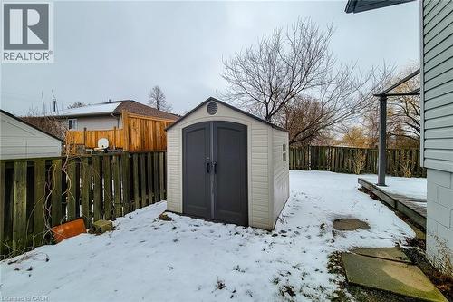 Snow covered structure featuring a fenced backyard and a shed - 758 Stone Church Road E, Hamilton, ON - Outdoor With Exterior