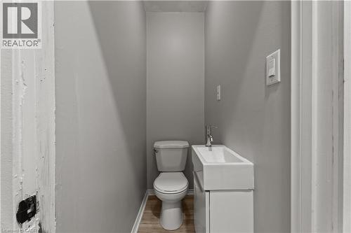 Half bathroom featuring vanity and wood finished floors - 88 Gage Avenue S, Hamilton, ON - Indoor Photo Showing Bathroom
