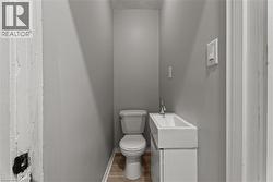 Half bathroom featuring vanity and wood finished floors - 