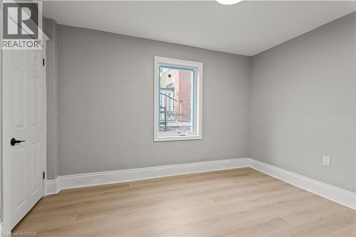 Unfurnished room featuring light wood-type flooring and baseboards - 88 Gage Avenue S, Hamilton, ON - Indoor Photo Showing Other Room
