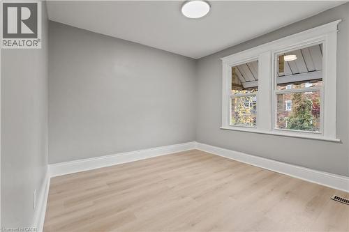 Unfurnished room with light wood-style floors and baseboards - 88 Gage Avenue S, Hamilton, ON - Indoor Photo Showing Other Room