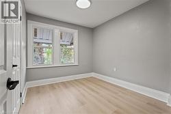 Unfurnished room featuring baseboards and light wood-type flooring - 