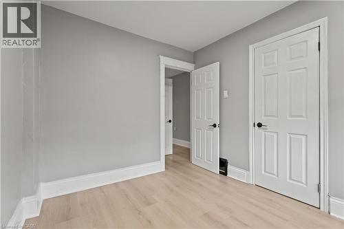 Unfurnished bedroom featuring baseboards and light wood-style floors - 88 Gage Avenue S, Hamilton, ON - Indoor Photo Showing Other Room