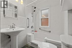 Full bathroom featuring tile walls and bathtub / shower combination - 