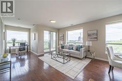 Living room with an office area, hardwood / wood-style floors, and plenty of natural light - 