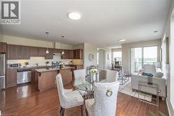 Dining area featuring dark wood finished floors - 