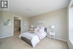 Carpeted bedroom featuring baseboards and connected bathroom - 