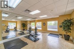 Workout room featuring a paneled ceiling - 
