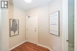 Hallway with wood finished floors and baseboards - 