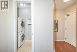 Laundry room with stacked washer / drying machine and baseboards - 