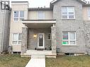 View of front facade with a porch, brick siding, and a front yard - 65 Old School Trail Unit# 36, Welland, ON  - Outdoor 