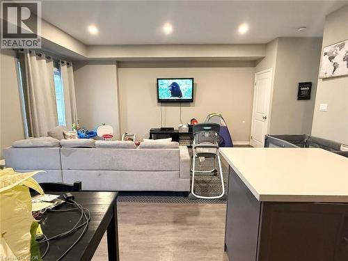 Living area with light wood-type flooring and recessed lighting - 65 Old School Trail Unit# 36, Welland, ON - Indoor