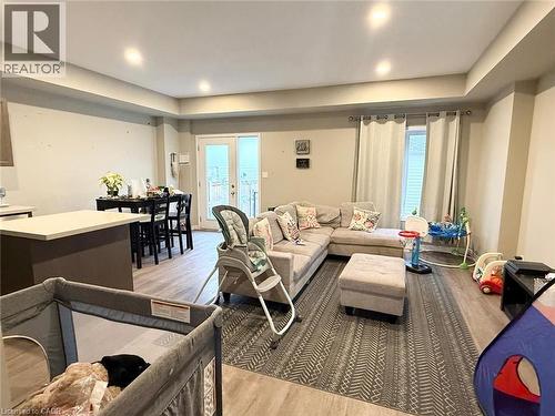 Living room with light wood-style flooring, french doors, recessed lighting, and healthy amount of natural light - 65 Old School Trail Unit# 36, Welland, ON - Indoor Photo Showing Living Room