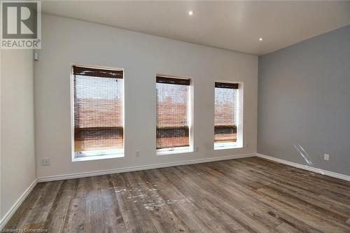 Spare room with baseboards and wood finished floors - 329 King Street E Unit# 3, Hamilton, ON - Indoor Photo Showing Other Room