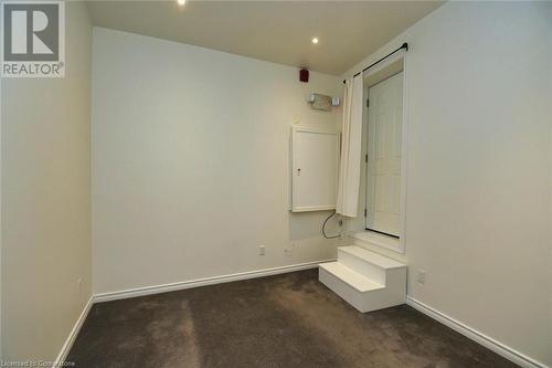 Unfurnished room with baseboards and dark carpet - 329 King Street E Unit# 3, Hamilton, ON - Indoor Photo Showing Other Room