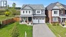 View of front of home featuring driveway, a porch, an attached garage, brick siding, and a shingled roof - 62 Esther Crescent Unit# Lower, Thorold, ON  - Outdoor With Facade 