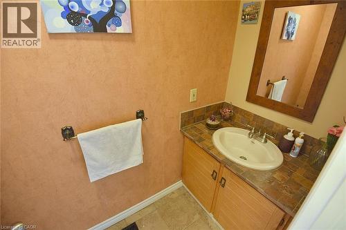 Bathroom featuring vanity, light tile patterned flooring, and tasteful backsplash - 43 Niska Drive, Waterdown, ON - Indoor Photo Showing Bathroom