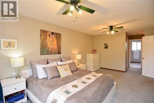 Bedroom with a ceiling fan, a textured ceiling, and carpet flooring - 43 Niska Drive, Waterdown, ON - Indoor Photo Showing Bedroom