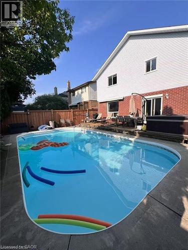 View of swimming pool with a hot tub, a fenced backyard, and a patio area - 43 Niska Drive, Waterdown, ON - Outdoor With In Ground Pool With Backyard