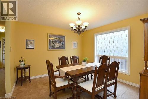 Dining room with a textured ceiling and a chandelier - 43 Niska Drive, Waterdown, ON - Indoor Photo Showing Dining Room