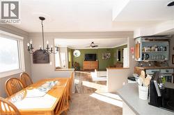 Dining room featuring a ceiling fan, ornamental molding, and a chandelier - 