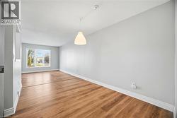 Unfurnished dining area featuring wood finished floors and a textured ceiling - 