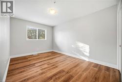 Spare room featuring light wood-type flooring and baseboards - 
