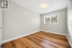 Unfurnished room with wood finished floors and baseboards - 