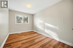Empty room with wood finished floors and baseboards - 