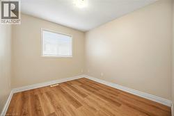 Spare room featuring wood finished floors and a textured ceiling - 