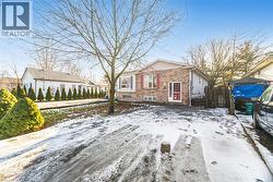 Snow covered property featuring brick siding - 