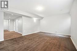 Empty room with dark wood finished floors and baseboards - 