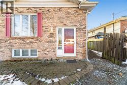 Entrance to property with a patio and brick siding - 