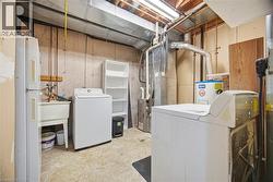Washroom featuring washer / clothes dryer, heating unit, and water heater - 