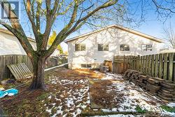 Rear view of house with a fenced backyard - 