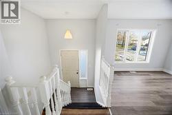 Foyer entrance featuring dark wood finished floors and baseboards - 