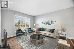 Living area featuring a textured ceiling and wood finished floors - 