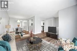 Living area with baseboards and wood finished floors - 