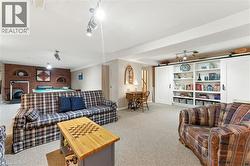 billiards, a brick fireplace, and a barn door - 