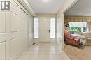 Foyer entrance featuring light tile patterned floors, a wainscoted wall, a decorative wall, a textured ceiling, and light colored carpet - 3 Atkins Drive, Hamilton, ON  - Indoor Photo Showing Other Room 