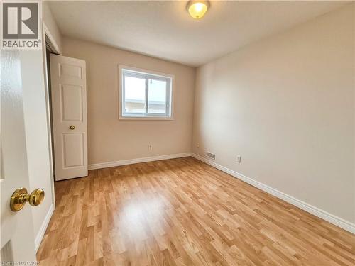 Unfurnished bedroom featuring a closet and light wood-style flooring - 132 Udvari Crescent Unit# 3, Kitchener, ON - Indoor Photo Showing Other Room