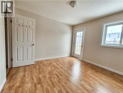 Spare room featuring light wood-type flooring and a textured ceiling - 132 Udvari Crescent Unit# 3, Kitchener, ON - Indoor Photo Showing Other Room