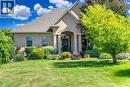 View of front of property with a front lawn, stucco siding, and a shingled roof - 86 Canters Close, Kitchener, ON  - Outdoor With Facade 