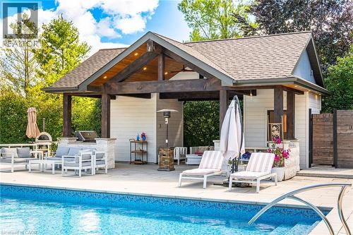 Outdoor pool featuring a patio, area for grilling, an outdoor structure, and a storage structure - 86 Canters Close, Kitchener, ON - Outdoor With In Ground Pool With Deck Patio Veranda
