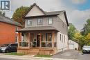 View of front of house featuring a shingled roof, covered porch, and brick siding - 238 Eagle Street S, Cambridge, ON  - Outdoor With Deck Patio Veranda With Exterior 