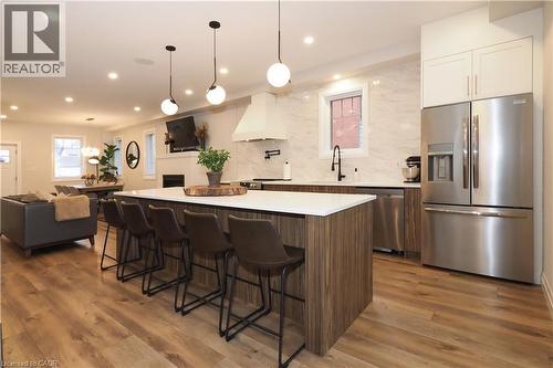 Kitchen with stainless steel appliances, tasteful backsplash, a large island, open floor plan, and custom exhaust hood - 238 Eagle Street S, Cambridge, ON - Indoor Photo Showing Kitchen With Upgraded Kitchen