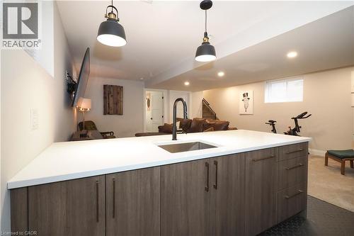 Kitchen featuring open floor plan, modern cabinets, hanging light fixtures, dark carpet, and recessed lighting - 238 Eagle Street S, Cambridge, ON - Indoor