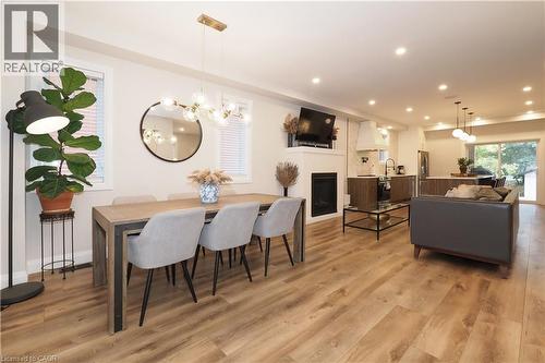 Dining space featuring a fireplace, a chandelier, light wood finished floors, and recessed lighting - 238 Eagle Street S, Cambridge, ON - Indoor